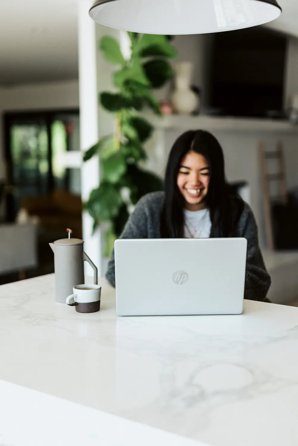 Happy woman looking at computer screen